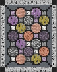 a quilt with many different colors and shapes