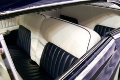 the interior of a classic car with black and white leather upholstered seats,