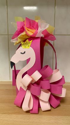 an origami flamingo with a crown on its head