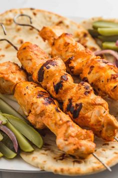 chicken skewers with vegetables on a plate