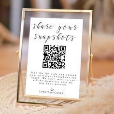 a qr code is displayed in front of a sign that says share your snapshots