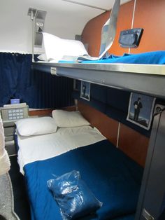 there is a bunk bed with blue sheets on it