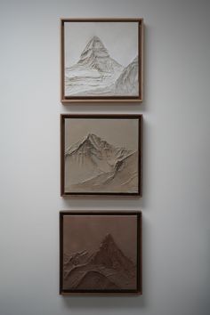 three paintings hang on the wall above each other