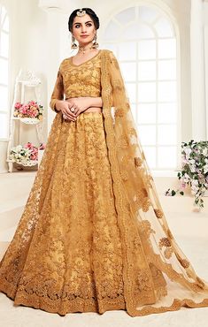 This Lehenga Choli is Ready to Wear A stunning lehenga with beautiful Floral Embroidered Net blouse, dupatta and lehenga, designed specially for wedding season Blouse & Lehenga Fabric - Net Inner Fabric - Santoon Dupatta Fabric - Net Color: Golden Style - Bridal Lehenga Embroidery: Cording & Thread Choli Length - 16 Inches Lehenga Length - 44 Inches NOTE : Originally stitched in size 42 but can be altered for size 40 & 44 without any extra cost. Golden Bridal Lehenga, Net Lehenga Choli, Simple Lehenga, Indian Princess, Net Blouses, Lehenga Online, Net Lehenga, Lehenga Choli Online, Neck Deep