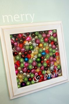 a white frame with christmas ornaments and the word bright on it in red, green, yellow and blue