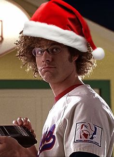 a man wearing a santa hat holding a laptop