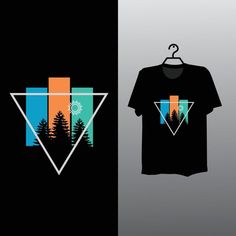 a t - shirt with the image of trees and mountains is hanging on a hanger