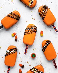 candy pops decorated with halloween decorations and eyes