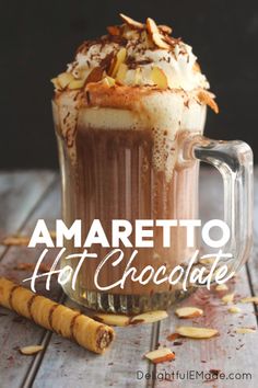 amaretto hot chocolate in a glass mug with whipped cream and toasted almonds