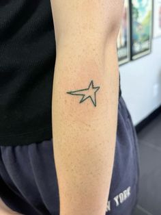 a person with a star tattoo on their arm