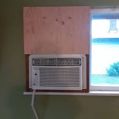 an air conditioner sitting on top of a window sill