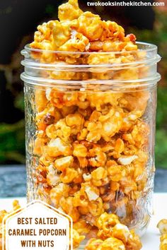 a glass jar filled with popcorn sitting on top of a table