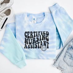 Get ready to fall in LOVE with your new tie-dye Certified Nursing Assistant (CNA) sweatshirt. It's the cutest and most comfortable way to show off the latest styles. Also makes a great gift! * PRODUCT DETAILS * ✺ 80% ring-spun cotton, 20% polyester ✺ Medium heavy weight fabric  ✺ Designed and printed in the USA ✺ Slight color variations may occur due to the dyeing process.✺ * SIZING * ✺ FOR AN OVERSIZED FIT, SELECT TWO OR THREE SIZES UP FROM YOUR NORMAL SIZE ✺ ✺ Sizing is unisex ✺ Size guide: Pl Tie Dye Long Sleeve Sweatshirt With Letter Print, Tie Dye Cotton Sweatshirt For Loungewear, Relaxed Fit Tie Dye Sweatshirt With Graphic Print, Cotton Tie Dye Sweatshirt For Loungewear, Tie Dye Cotton Sweatshirt Relaxed Fit, Tie Dye Relaxed Fit Cotton Sweatshirt, Relaxed Fit Cotton Tie-dye Sweatshirt, Relaxed Fit Tie Dye Cotton Sweatshirt, Cotton Tie Dye Sweatshirt