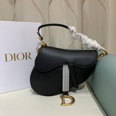 The iconic Saddle bag is reinvented once more by Maria Grazia Chiuri. Featuring a Saddle flap with a magnetic 'D' stirrup clasp, it boasts a 'CD' signature on each side of the handle. The black grained calfskin style is embellished with antique gold-finish metal hardware. The Saddle bag may be carried by hand or over the shoulder and can be customized with different shoulder straps. Magnetic 'D' stirrup closure 'CD' signature on the strap Interior pocket Back pocket Dust bag included Made in Italy Christian Dior Saddle Bag, Dior Saddle, Maria Grazia Chiuri, Maria Grazia, Handbag Wallet, Wallet Accessories, Saddle Bag, Diaper Backpack, Metal Hardware