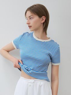 This is KLEAN’s features an ecru-colored contrast ribbing on the neckline and cuffs. The sturdy ribbed texture of the striped fabric creates a lively and casual marine look. Made with a 20-count knit, it offers a substantial thickness with a firm and dense texture. The neckline is sewn with a durable method to prevent deformation, and the shoulder line is reinforced with silicone taping for added durability.- Ideal for everyday wear- Pairs well with various bottoms to create diverse looks- A basic item that complements any outfit stylishly Fitted Striped Tops With Ribbed Cuffs, Striped Crew Neck Top With Ribbed Collar, Fitted Striped Top With Ribbed Cuffs, Striped Fitted Top With Ribbed Cuffs, Cotton T-shirt With Side Stripes, Sporty Blue T-shirt With Three Stripes Branding, Striped T-shirt With Contrast Stripes And Relaxed Fit, Blue T-shirt With Contrast Stripes, Silicone Tape