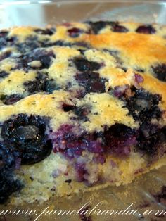 a close up of a cake with blueberries on it