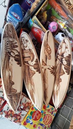 three wooden surfboards sitting next to each other