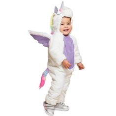 a toddler in a unicorn costume standing on one leg and smiling at the camera