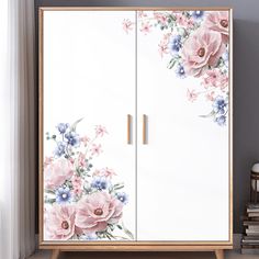 a white cabinet with flowers painted on it