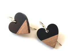 two heart shaped wooden earrings on white background