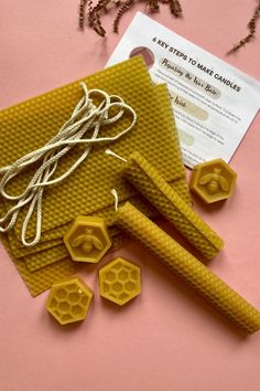 beeswax and honeycombs are on the table next to a paper bag