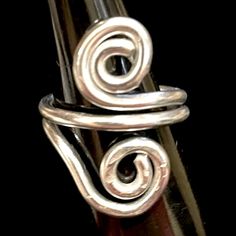 a close up of a metal object with spirals on it's end and two rings