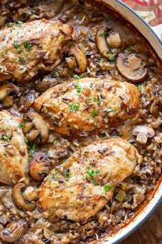 chicken and mushroom stew in a pan on a wooden table