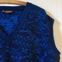 "Gorgeous vintage 80s Yves Saint Laurent sleeveless sweater tank. In all things blue. It's like a petrol blue running through it which gives it such a depth of colour. Made from wool and acrylic condition is used but very good. No snags or pulls found. It's a real gem. Size wise it states L and measures a 50\" chest. We do accept returns but only if the item has been grossly misdescribed and not because you have a change of mind or you have not checked measurements carefully we're afraid. Any questions please ask. Many thanks" Blue Knit V-neck Vest, Blue Sleeveless Sweater Vest For Winter, Blue Sleeveless Casual Sweater, Blue Sleeveless Knit Sweater, Blue Knit Sweater Vest For Fall, Fitted Blue Sweater Vest For Winter, Fitted Sleeveless Blue Sweater, Blue Knit Sleeveless Vest, Blue V-neck Knit Vest