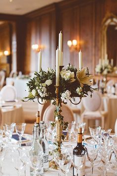 the table is set with wine glasses and candles