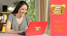 a woman smiles as she uses her laptop