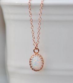 "A sweet new necklace using 14K rose gold and opal. The opal is oval shaped and white in color. It has broad rainbow flashes and excellent fire. Opal is hand set into a premium, rose gold plated crown setting. It hangs from 14K rose gold filled chain, in your length of choice. Opal measures 10mm tall (just under 1/2\") while entire pendant measures 3/8\" long. Please choose desired chain length at checkout. Please see all of my rose gold opal pieces here: https://www.etsy.com/shop/hangingbyathre Elegant Pink Opal Jewelry Gift, Elegant Pink Opal Jewelry For Gift, Elegant Rose Gold Pink Opal Jewelry, Elegant Pink Opal Oval Jewelry, Rose Gold Pink Opal Round Jewelry, Rose Gold Pink Opal Jewelry, Oval Pink Opal Jewelry Gift, Oval Pink Opal Jewelry For Gifts, Gold Oval Pink Opal Jewelry