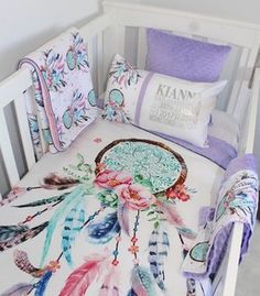 a baby crib with a blanket and pillows on it