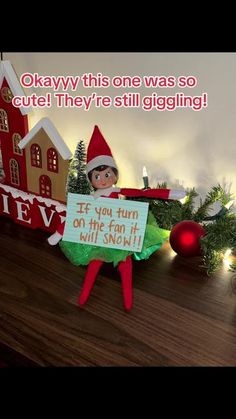 an elf is holding a sign in front of christmas decorations