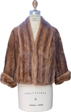 1950s Light Brown Mink Fur Capelet Stole with Arm HolesElegante Paris New Yorktaupe matte satin lining2 outer front pocketssleeves of sortsdouble large hook and eyessize unknown - please see measurements for most accurate sizing- this is for a smaller fram if you want to close~15 shoulders21" center back length24" center front length 19" sleeve length shoulder to cuffnice condition with the slightest wear along inner neck below ruffle 1950s Formal Fall Outerwear, Classic Mink Color Formal Outerwear, Classic Mink-colored Formal Outerwear, Vintage Mink-colored Formal Outerwear, Vintage Formal Mink-colored Outerwear, Vintage Formal Mink Outerwear, Vintage Formal Outerwear In Mink Color, Fur Capelet, Mink Stole