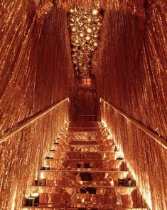 the stairs are lined with lights and balls in an elaborately designed room that looks like it has been decorated for christmas