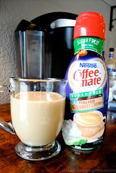 a cup of coffee next to a bottle of coffee mate