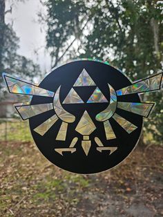 the legend of zelda wind catcher is made out of stained glass and has an emblem on it