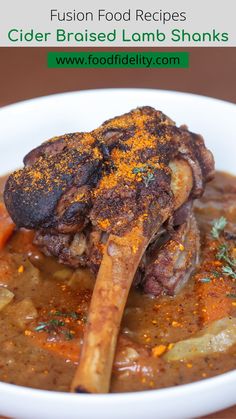 a close up of a bowl of food on a table with the words cider braised lamb shans