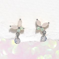 Capture the essence of springtime with our Wings of Wonder Dangle Earrings. A fresh take on our best-selling Mari butterfly design, these earrings feature a stunning combination of clear and light green stones that will leave you in awe. But that's not all - each butterfly's wing is adorned with an adorable dewdrop-like stone that dangles with every movement, adding a touch of playfulness and charm to the design. Let your sense of style take flight! Sloth Jewelry, Green Stones, Necklace Chain Lengths, Silver Earrings Dangle, Rose Gold Earrings, Rose Gold Color, Butterfly Wings, Butterfly Design, Green Stone