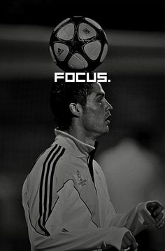 a black and white photo of a man with a soccer ball on his head that says focus