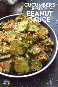 cucumbers in spicy peanut sauce on a plate with the title overlay reads cucumbers in spicy peanut sauce