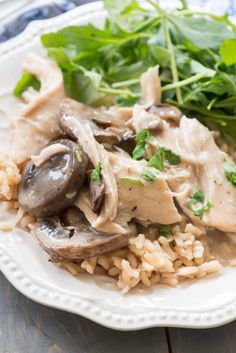 a white plate topped with rice and mushrooms