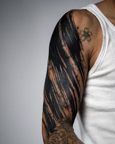 a man with a tattoo on his arm