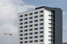 a tall white building with lots of windows