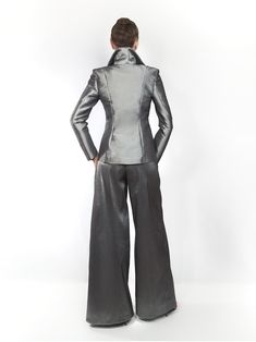 Our EXCLUSIVE limited edition. Dark silver semi stretch taffeta ladies pantsuit. Made exclusively to order in house. Introducing my latest obsession: a made-to-measure, dark-silver pantsuit that’s perfect for summer days at the office! ☀️ This sexy and feminine silhouette features strong shoulders and a stand-up collar, making a bold statement while keeping me comfortable all day long. 💃 Plus, it’s wrinkle-free, easy to care for, and incredibly flattering! 🌟 Say goodbye to wardrobe dilemmas and hello to effortless style with this must-have piece. CARE: Dry clean only TURNOUROUND TIME: 14 - 19 business days processing + shipping via USPS. You can choose express USPS express shipping as well. Contact us if you need to hurry. +++++++++++++++++++++++ Size Guide https://mologokocouture.com/pa Silver Elegant Evening Bottoms, Elegant Fitted Silver Bottoms, Elegant Fitted Silver Pants, Elegant Silver Pants For Evening, Elegant Silver Fitted Pants, Elegant Silver Party Pants, Luxury Fitted Satin Pants, Metallic Fitted Pants For Formal Occasions, Metallic Fitted Bottoms For Formal Occasions