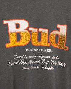 a man wearing a black shirt with the word bud on it