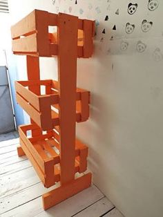 an orange shelf sitting on top of a wooden floor