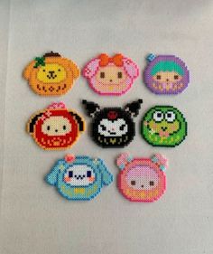 cross stitch halloween buttons on a white surface