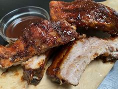 barbecue ribs and sauce on a cutting board