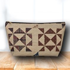 a brown and white bag sitting on top of a wooden table